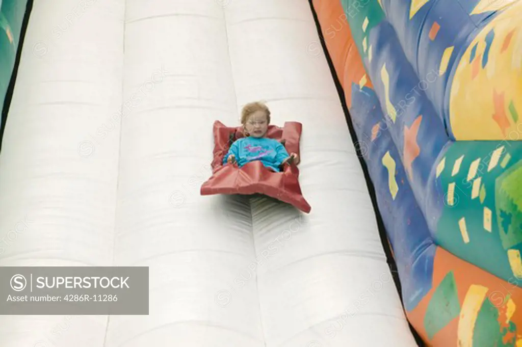 Young girl (3 yrs) on inflatable slide..MR-0501
