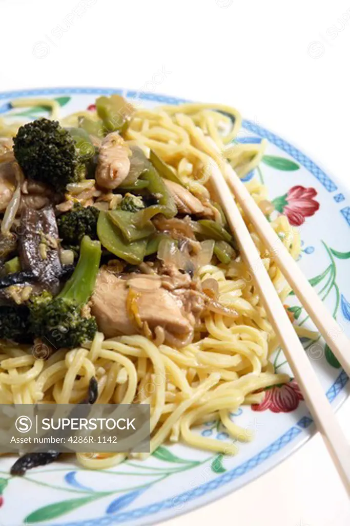 Chicken chow mein (canonese noodles) on a plate with chopsticks
