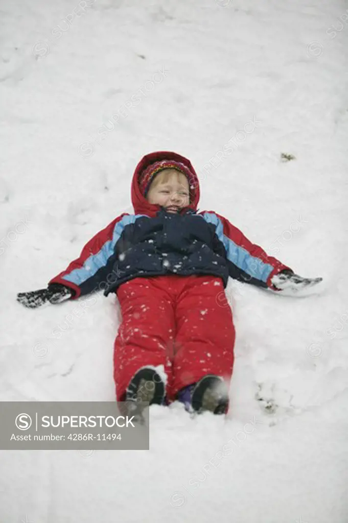 4 year old girl making snow angels.MR-0501