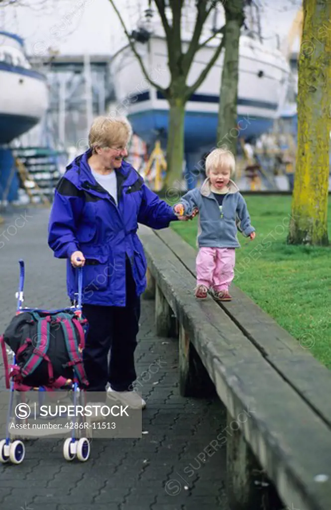 2 year old girl and grandmother. Granville Island Vancouver BC Canada.