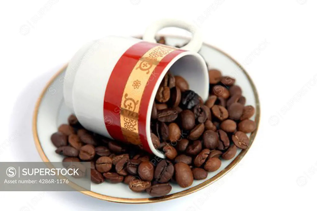 An Arab or Turkish-style coffee cup and saucer with a blend of coffee beans, with shadow