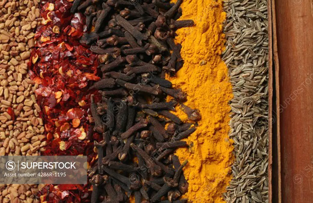 Curry spices, from left: fenugreek, crushed dried chillies, cloves, turmeric, cumin and cassia (or cinammon) sticks.