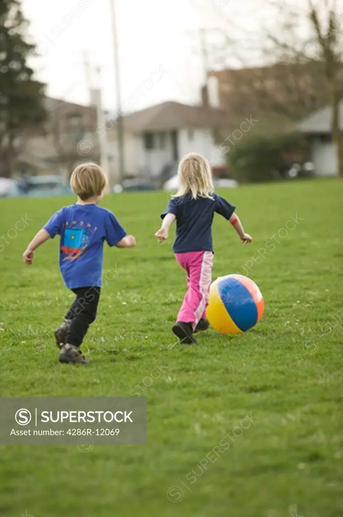 3 Year Old Boy and 4 Year Old Girl Playing With a Beachball at a Playground, MR-0601 MR-0518