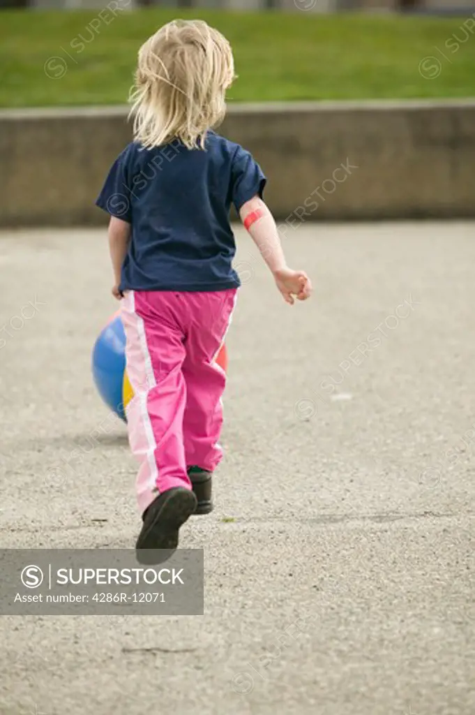 4 Year Old Girl Playing With a Beachball at a Playground, MR-0601