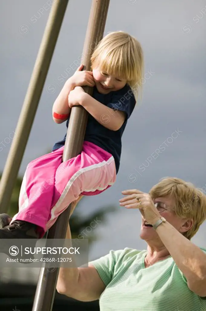 4 year Old Girl Sliding Down a Post at a Playground With Grandma Helping, MR-0601 MR-0618
