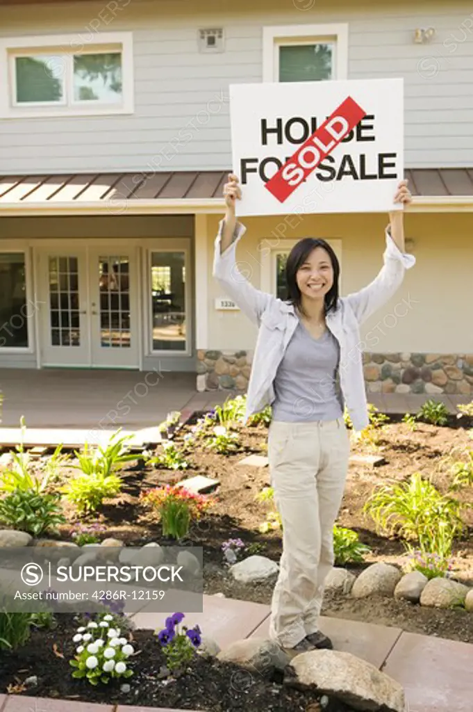 Asian Woman With a House For Sale Sold Sign