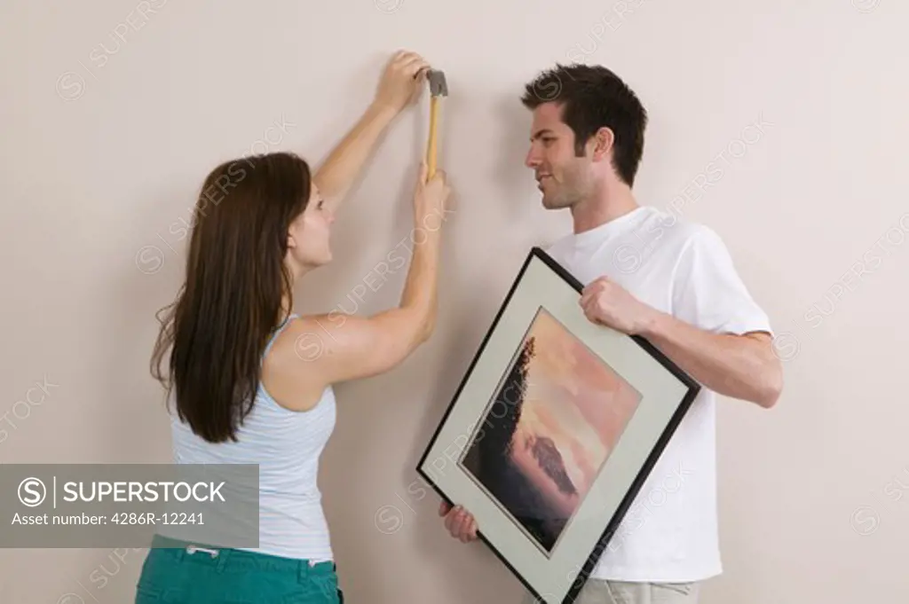 Couple Hanging a Picture