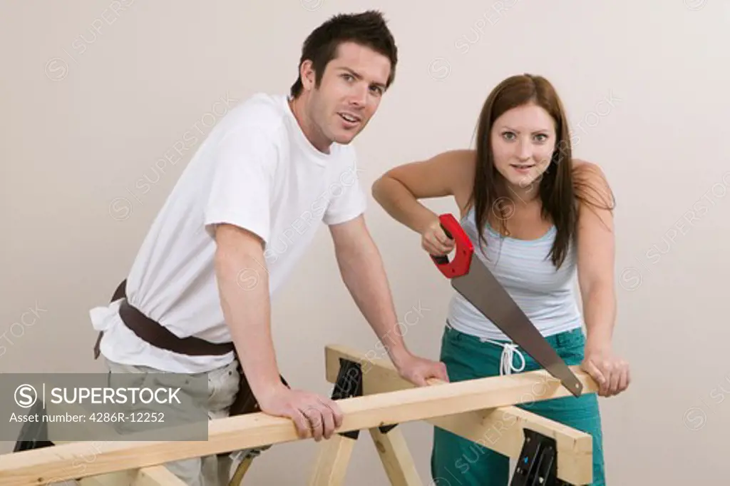 Couple Sawing a Board