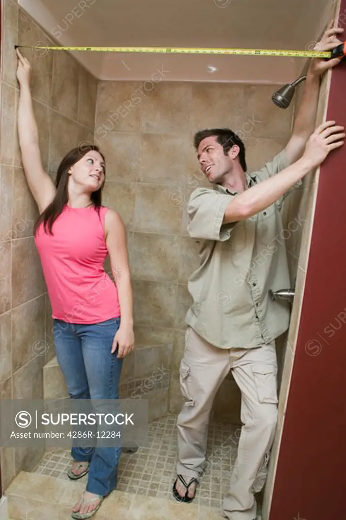 Couple Measuring For a Shower Curtain