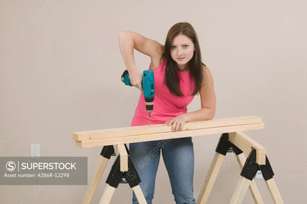 Woman Using a Power Screwdriver Drill