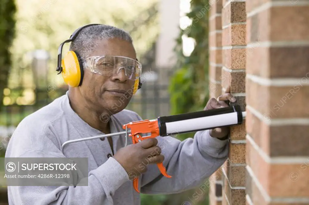African American Man Using a Caulking Gun, MR-0626 PR-0628