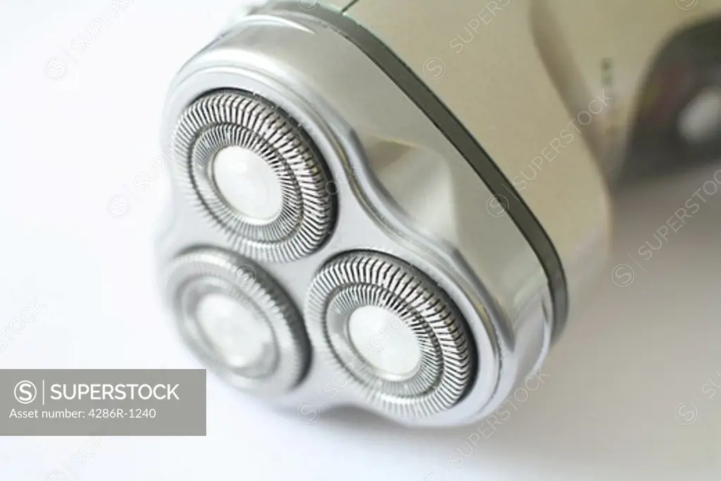 Close-up view of a portable electric razor on a white background