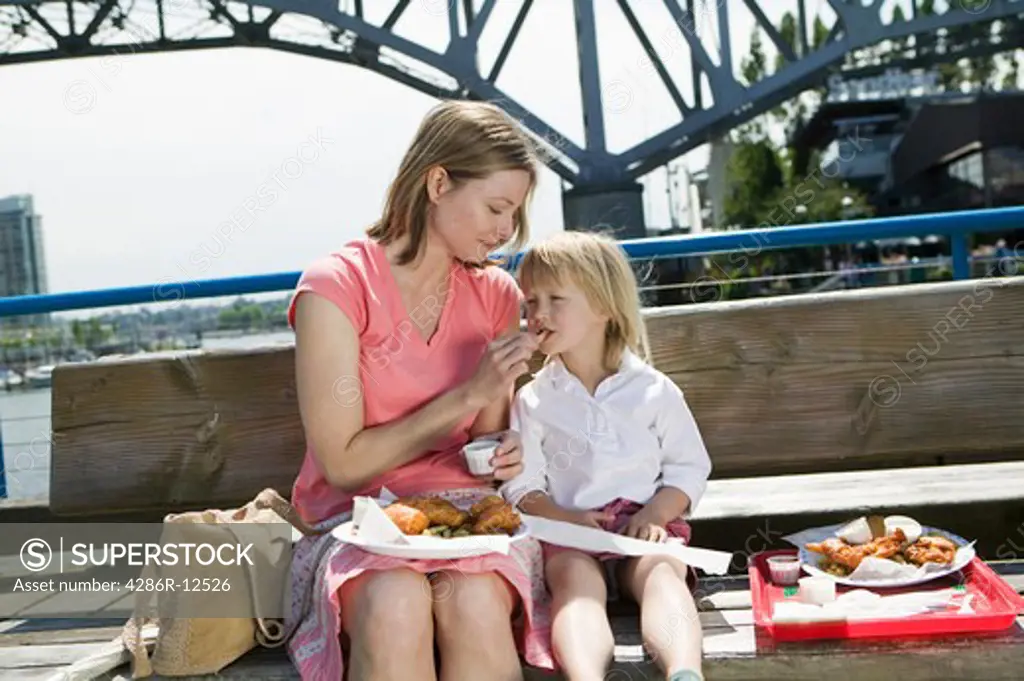 Mom And Daughter Having a Fish and Chips Lunch on Granville Island Vancouver, MR-0601 MR-0637