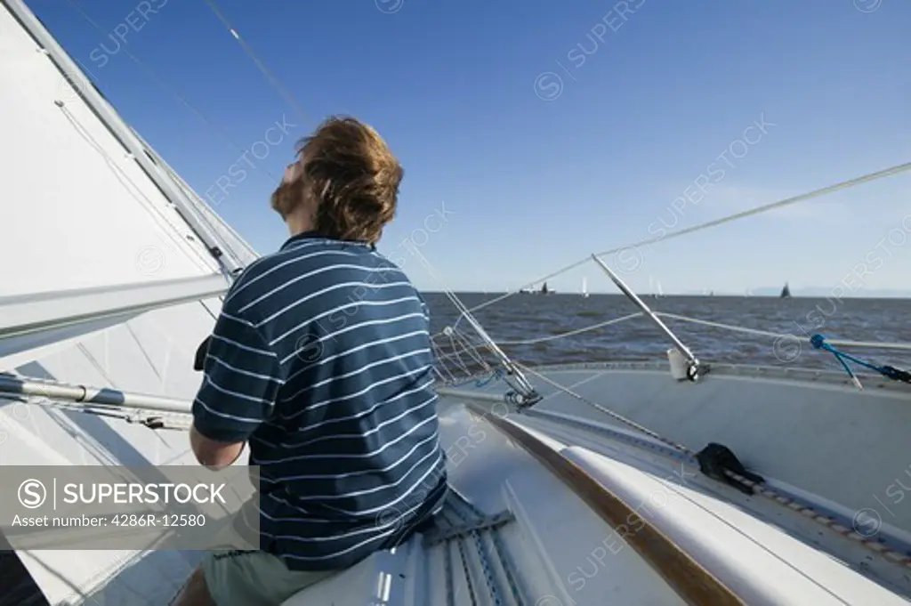 Man Relaxing on a Sailboat