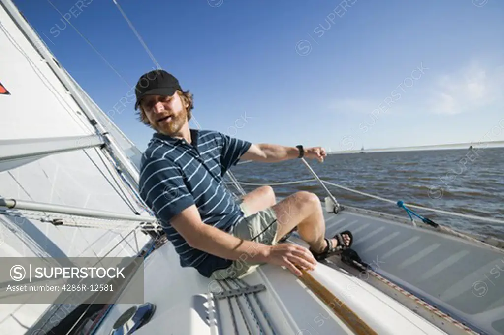 Man Relaxing on a Sailboat