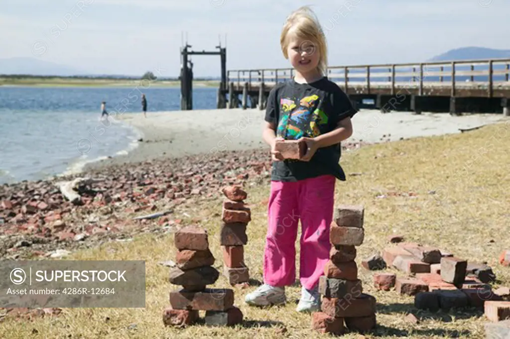 Young Girl Stacking Bricks Sidney Spit Marine Park BC Canada, MR-0601