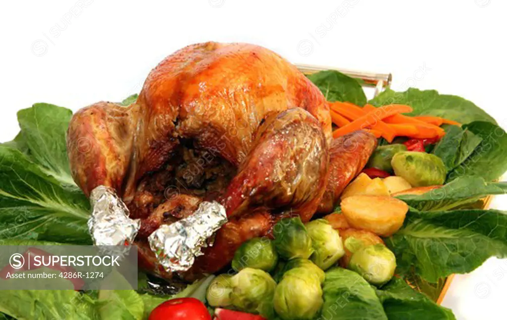 A festive turkey on a bed of lettuce with all the traditional trimmings
