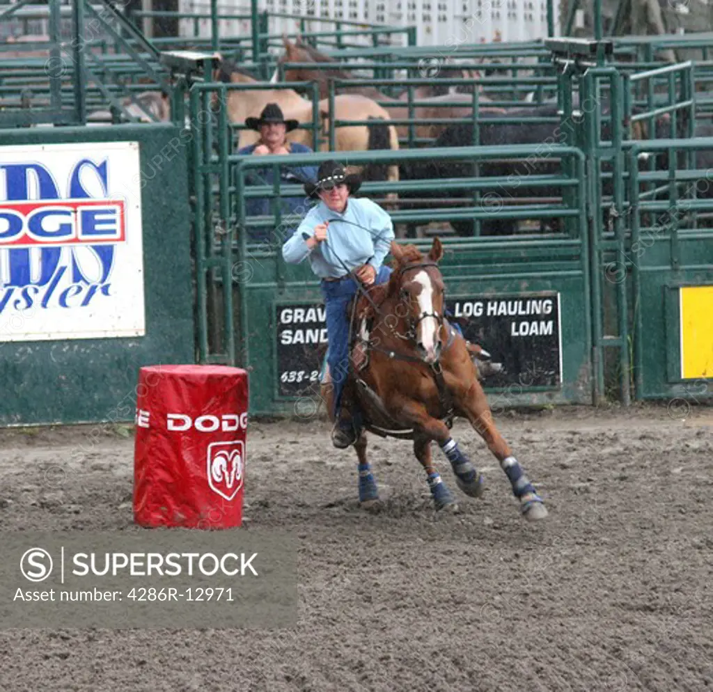 Cowgirl Rounds the Barrel at a Small Town Rodeo