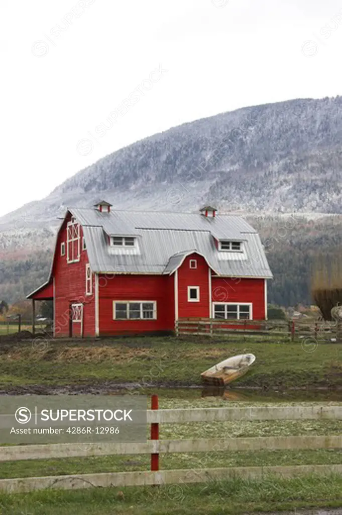 Classic Red Barn with snowy mountain behind, Fraser Valley BC