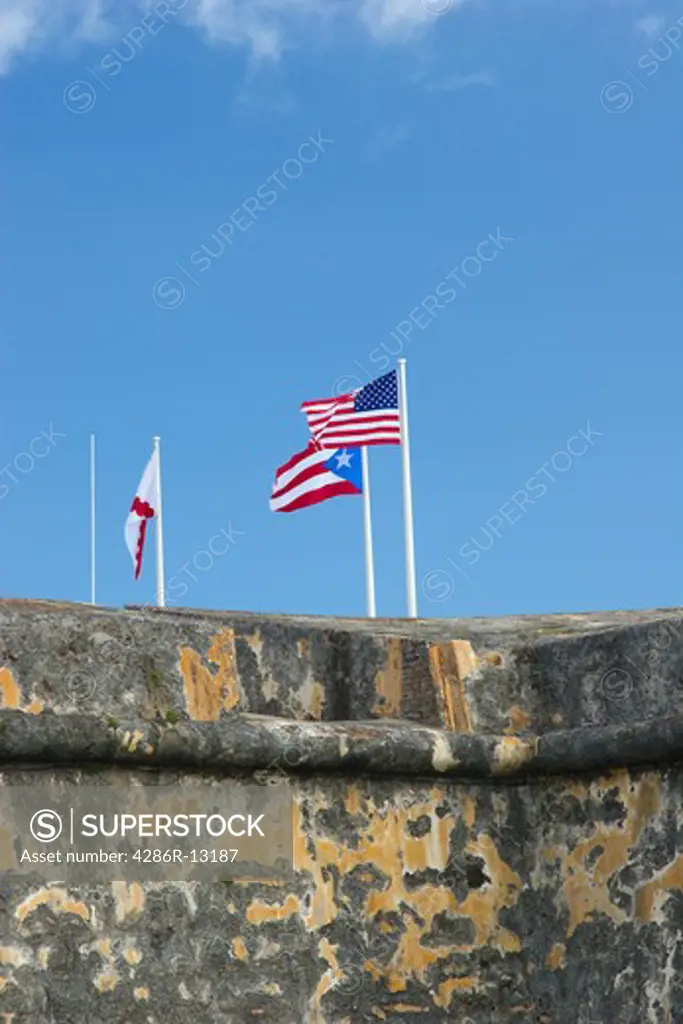 US and Puerto Rican flags flying at Castillo de San Felipe del Morro in old San Juan, Puerto Rico