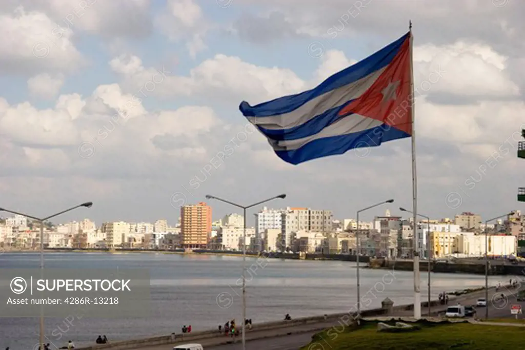 View overlooking the Malecon and Centro Habana and Old Havana. Large Cuban flag is in the foreground