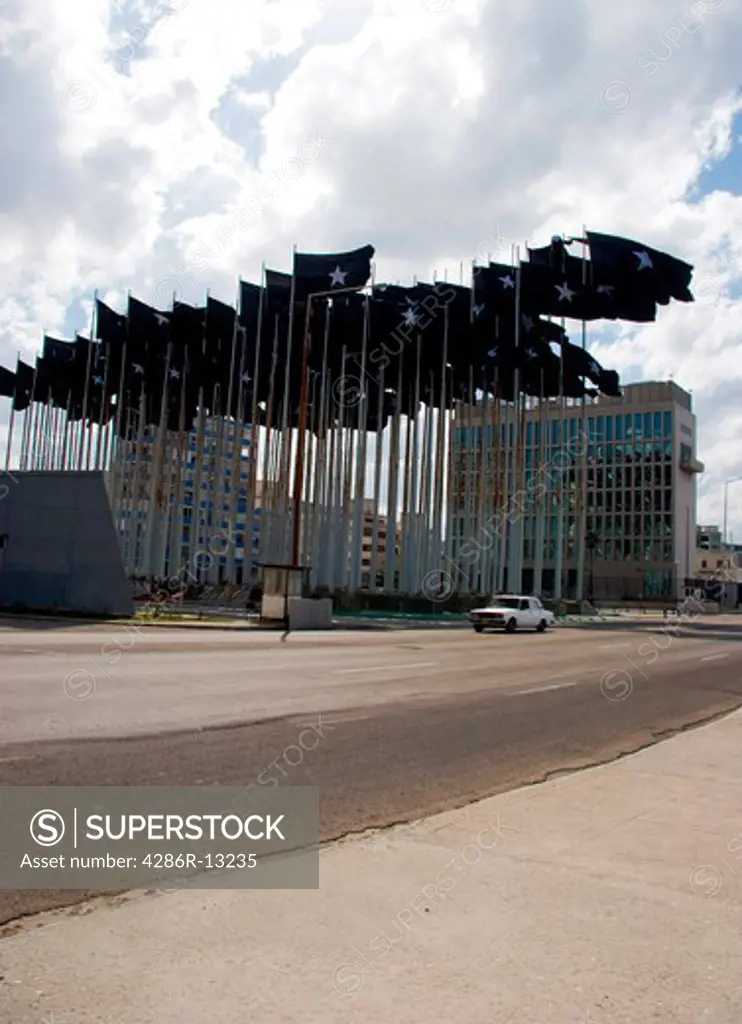 Numerous black flags with single star fly in front of former US Embassy in Havana, Cuba. These flags were erected in an attempt to block American propaganda broadcasts.