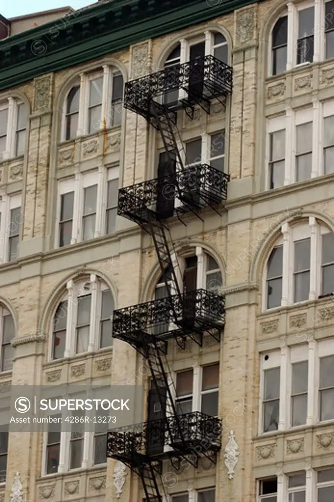 black wrought iron fire escape on apartment building, Manhattan, New York