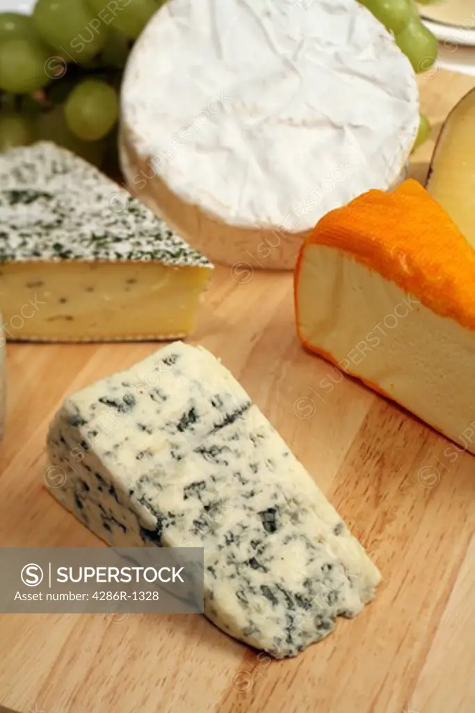 A cheeseboard, Danish blue to the front, with a selection of gourmet cheeses