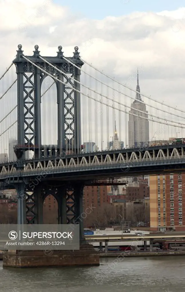 View of Manhattan Bridge and Empire State Building from the walkway on the Brooklyn Bridge, New York