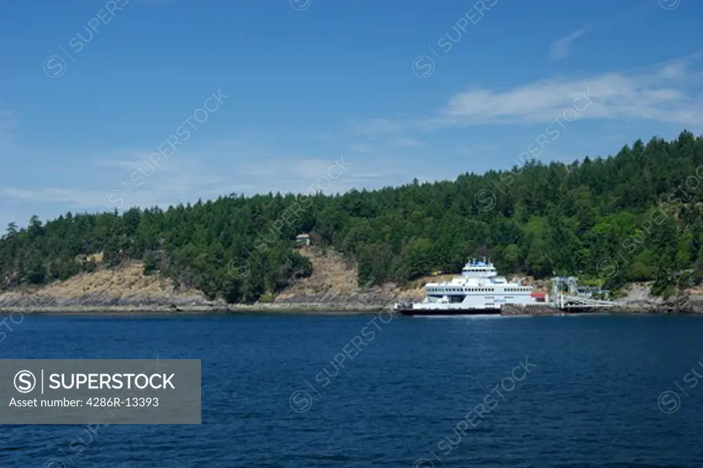 Small car and passenger ferry pulls into dock at Pender Island, BC