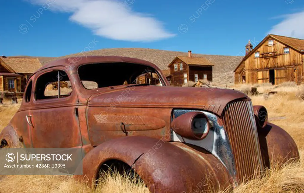 Abandoned, rusted out coupe in historic town of Bodie, California