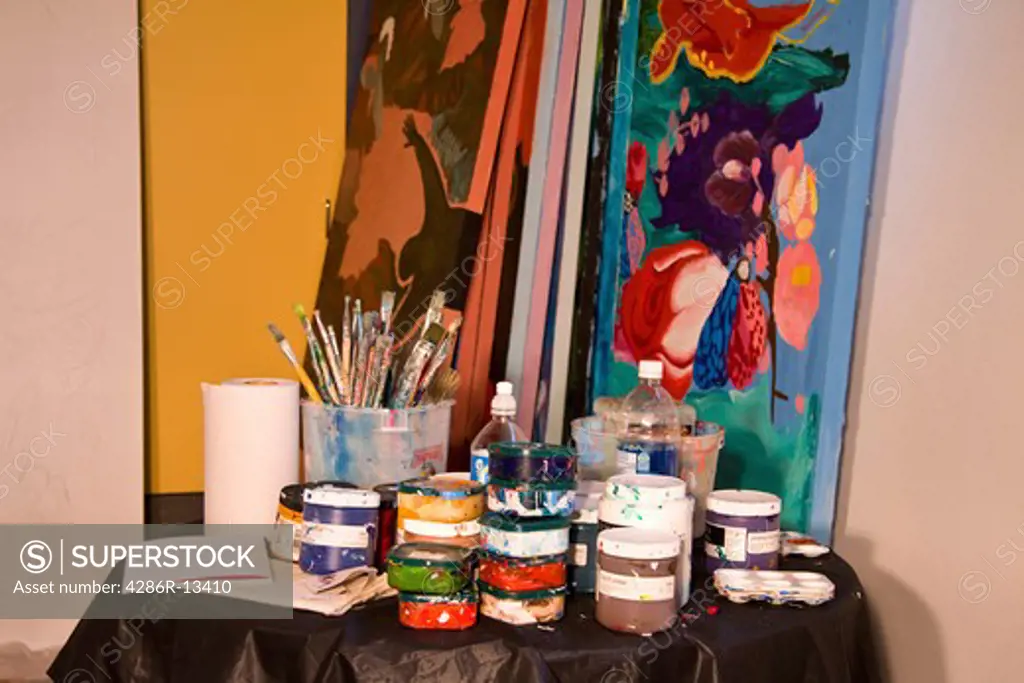Collection of oil paints and brushes in artists studio workshop