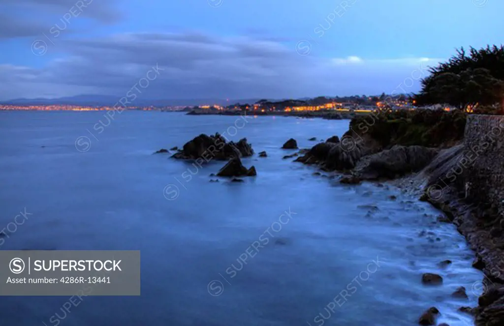 Shorleline walk in Pacific Grove at dusk, Monterey Bay at sunset, Central California, USA