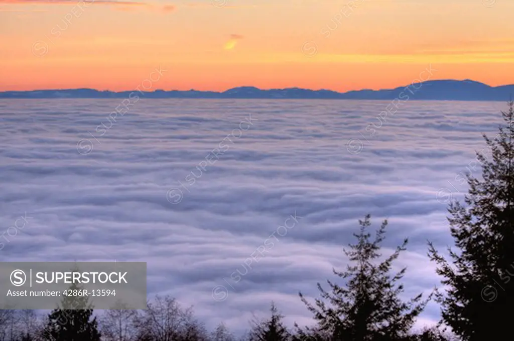Sunset above the fog, looking across the Strait of Georgia towards Vancouver Island
