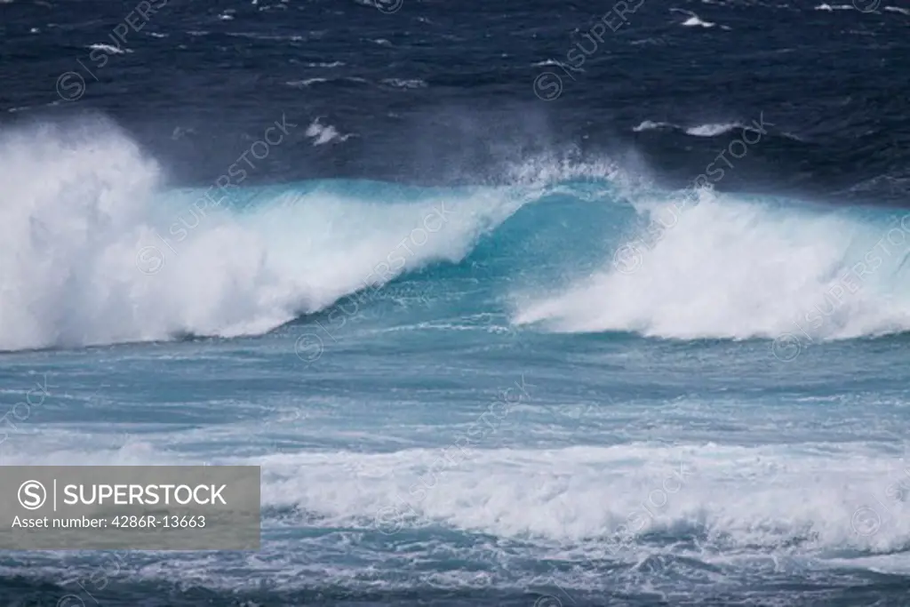Beautiful blue wave breaking at Hookipa Beach, located on the windy North Shore.