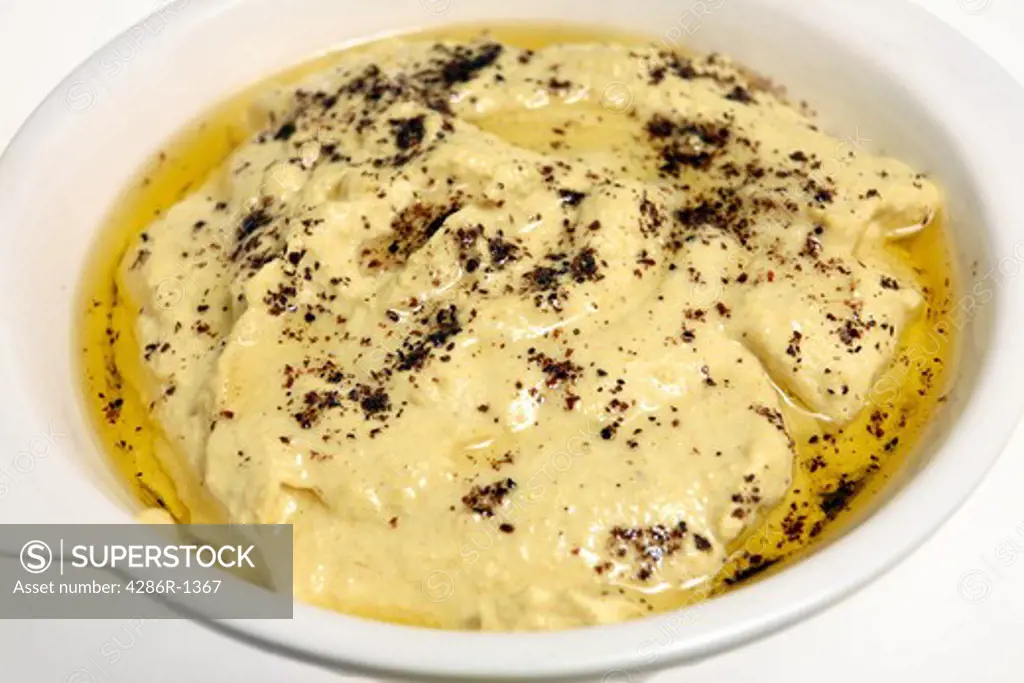 Middle-eastern hummus, sprinkled with sumac and olive oil.