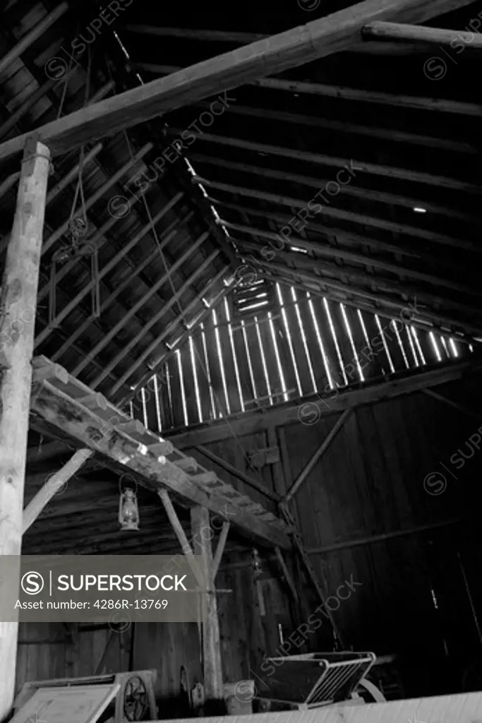 Inside of old pole barn at Historic Stewart Farm at Elgin Heritage Park, near Crescent Beach, Surrey, BC, Canada. Black and white