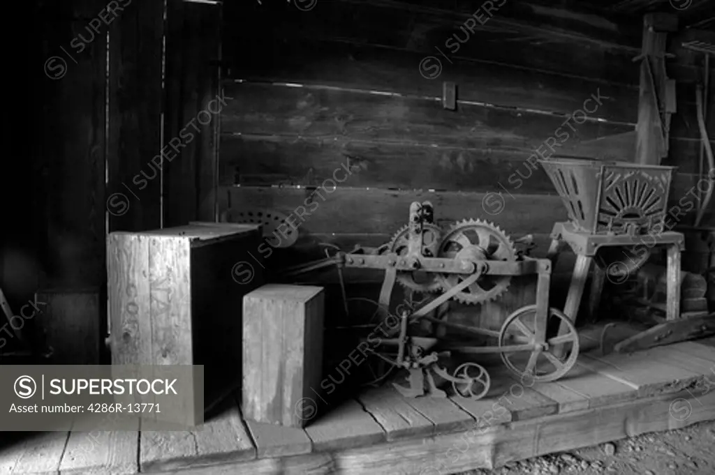 Old equipment and crates at Historic Stewart Farm at Elgin Heritage Park, near Crescent Beach, Surrey, BC, Canada. Black and white, also avail in color