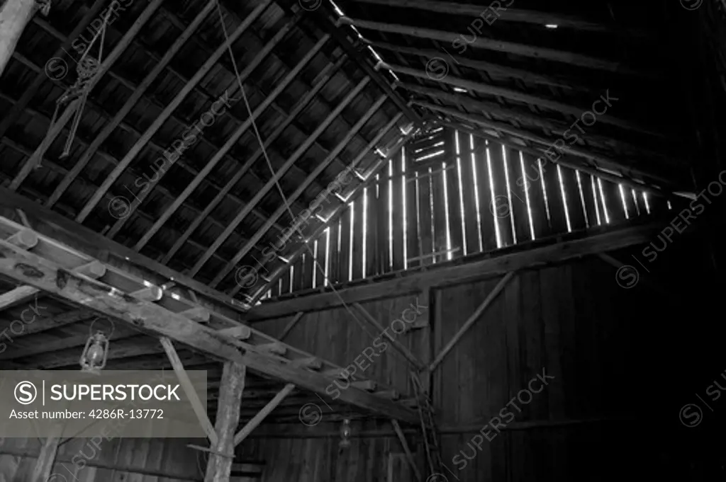 Inside of old pole barn at Historic Stewart Farm at Elgin Heritage Park, near Crescent Beach, Surrey, BC, Canada. Black and white, also avail in color