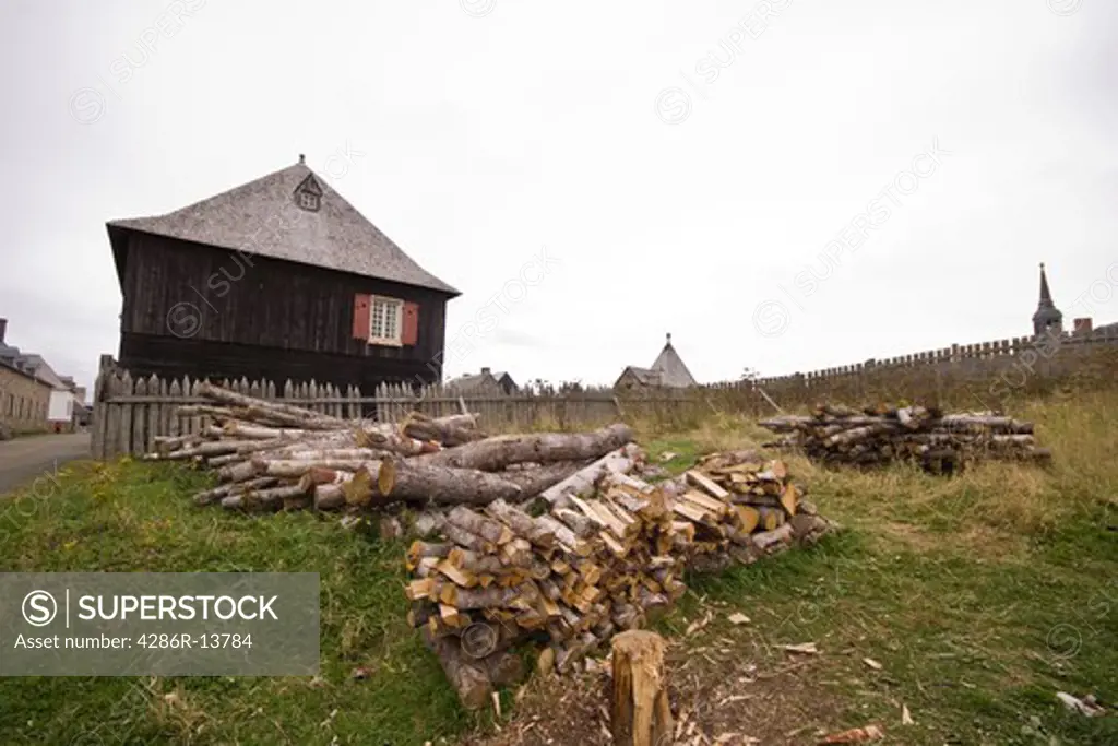 Getting ready for winter, freshly chopped pile of firewood at Fortress of Louisbourg National Historic Site, Cape Breton, Nova Scotia, Canada