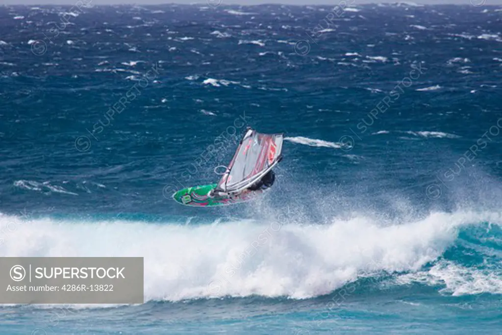 Tacking Horizontal. Extreme Windsurfing on Mauis famous Hookipa Beach, located on the windy North Shore.