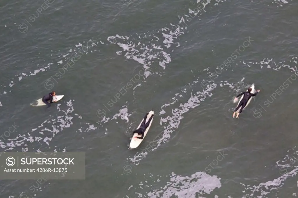 Aaerial View of 3 surfers in wet suits San Francisco Bay, California, USA