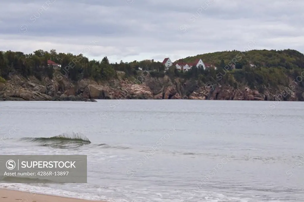 Ingonish Beach with little fanciful wave and the historic Keltic Lodge in the background, Cape Breton, Nova Scotia, Canada
