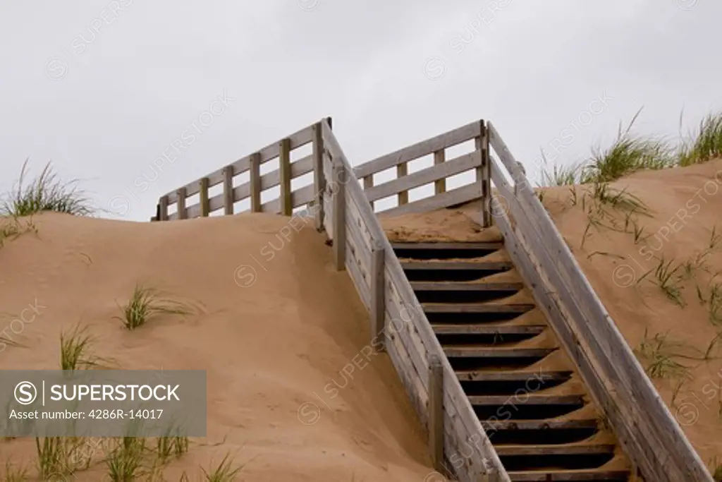 Wooden staird going up over the dunes to the beach. Prince Edward Island National Park, on the north shore of Prince Edward Island, Canada