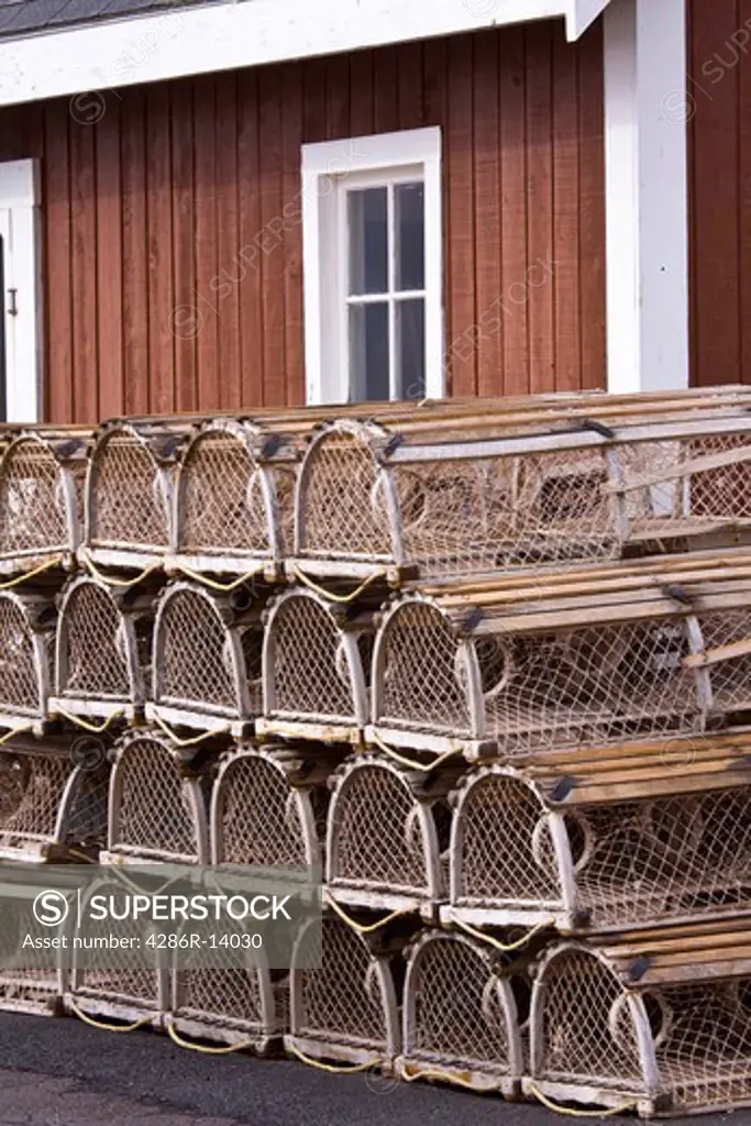 Rows of lobster traps in front of fishing shed, North Rustico Harbour on the north shore of Prince Edward Island, Canada