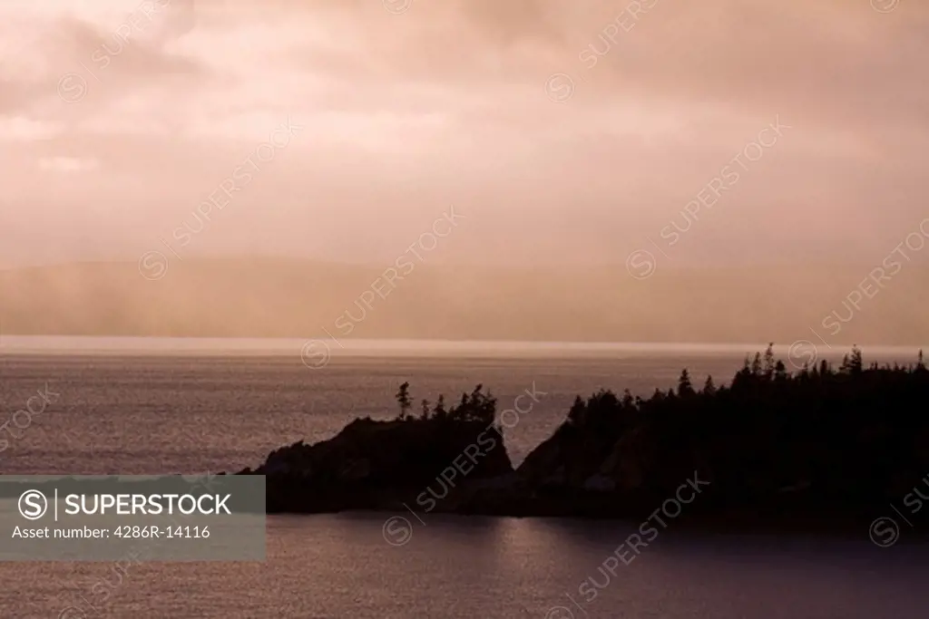 Misty rain over rugged coastal landscape in the Bay of Fundy, New Brunswick, Canada
