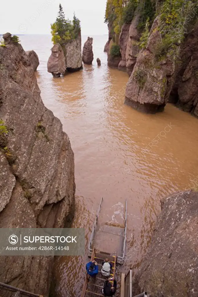 Tourists watching the dramatic tides come up the steps. Hopewell Rocks, Bay of Fundy, New Brunswick, Canada