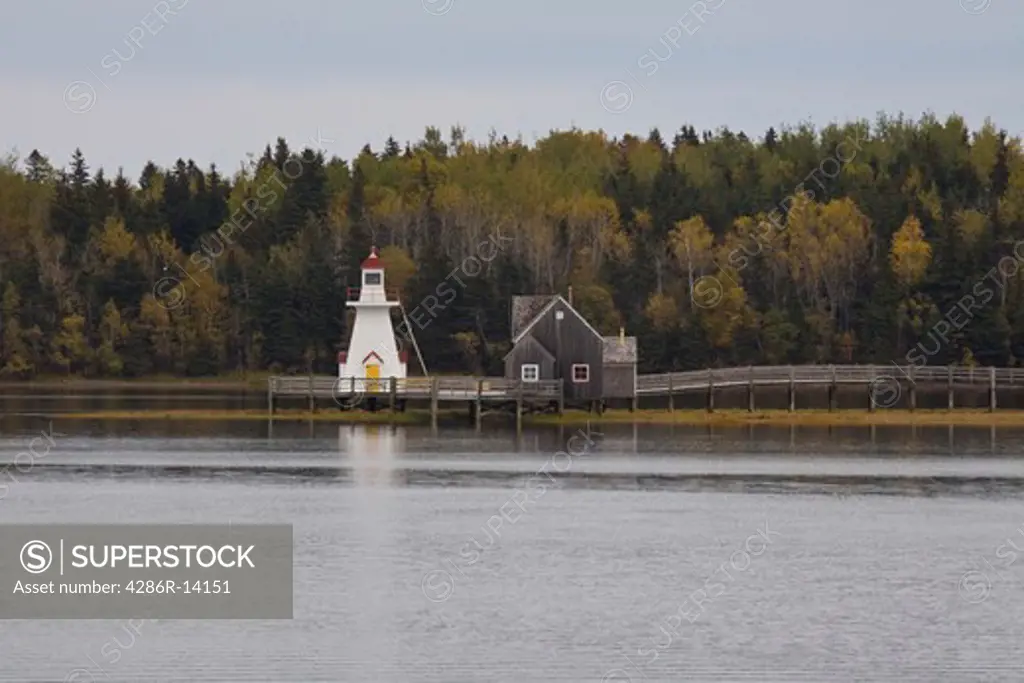 Lighthouse and pier at Recreated Acadian Village at Bouctouche, New Brunswick, Canada