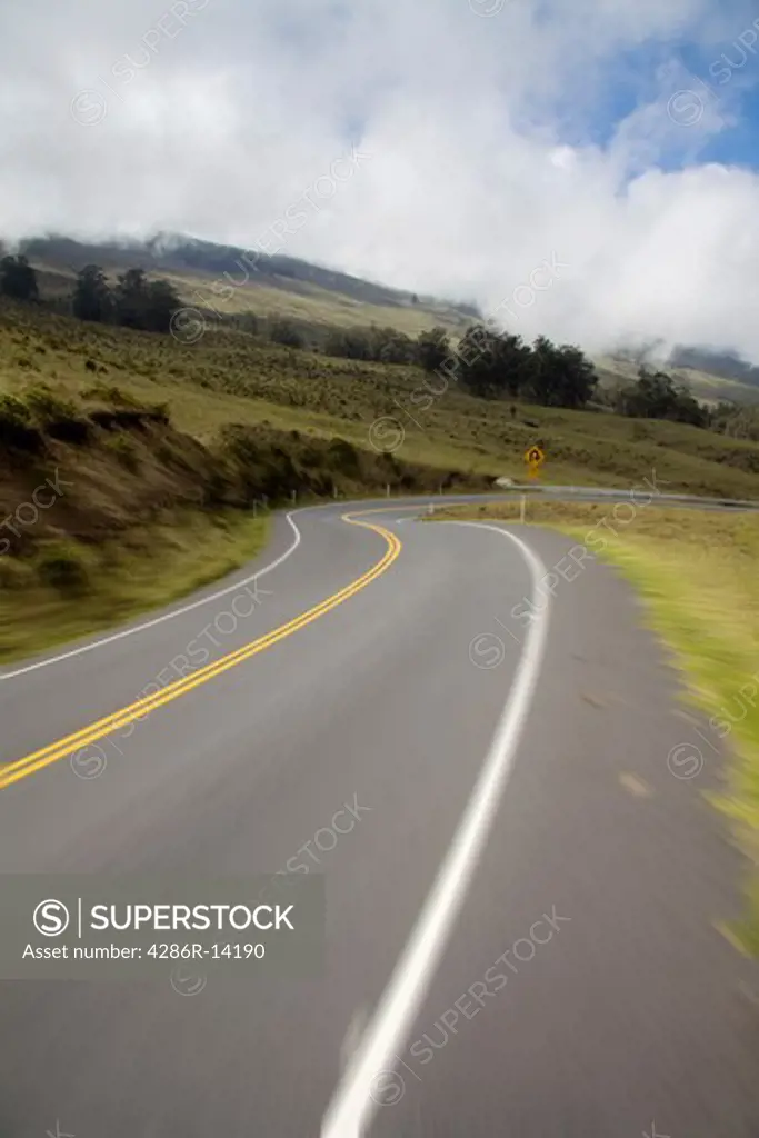 Riding down Haleakala highway in Haleakala National Park, Maui on a bike. Motion blur in foreground.