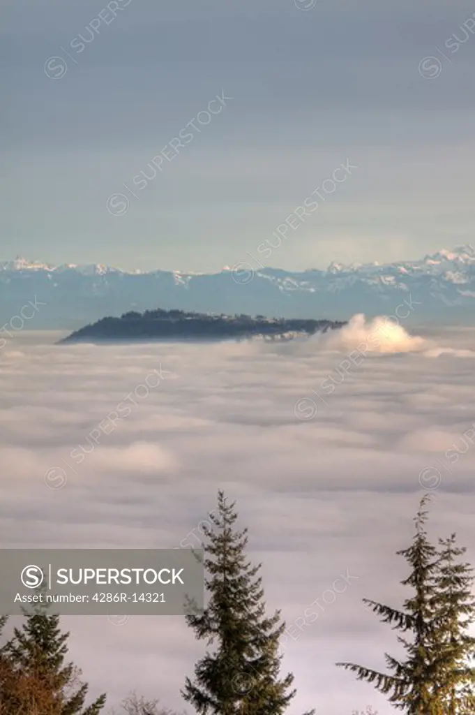 Up above Vancouver and the Fraser Valley shrouded in fog - Simon Fraser University and Burnaby Mountain visible above the clouds